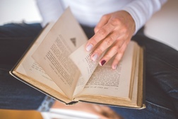 Picture of girl holding an open book in her hands
